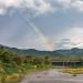 rainbow over hills with a river representing a custom essential oil blend