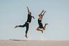 man_jumping_on_brown_sand-scopio-4x6