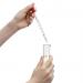 Hand using a glass pipette to fill a cylinder
