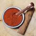 Sandalwood red powder in a brass bowl with copper spoon