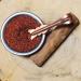 Red sandalwood chips in a brass bowl and copper spoon