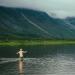 A man bathes in a mountain lake.