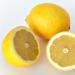 This image shows a whole and a cut lemon.