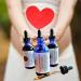 Bottles of serum in front of a pregnant belly with heart