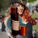 A bottle of Pirate Perfume in front of a red haired woman dressed as a pirate A bottle of Pirate Perfume in front of a red haired woman dressed as a pirate