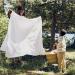 Hanging a sheet to dry outdoors by a river