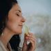 Woman enjoying the scent from a roll on bottle of perfume