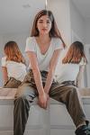 2_women_sitting_on_white_bed-scopio-4x6