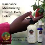 A hand holding a strawberry on the vine with Raindance Moisturizing Hand & Body 