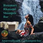 A woman bathes under a waterfall beside a stack of Rosemary Rhassoul Shampoo Bar