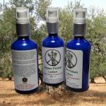 Lotion: Peace Potion bottles in front of olive trees