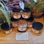 Anarres Twilight Delight Tea 8 jars arranged under house plants